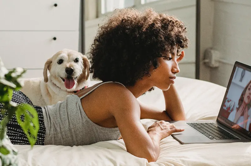 Woman with dog talking to a therapist online regarding obtaining an ESA Letter